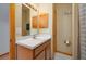 Cozy bathroom featuring a wood vanity with a light marble top and a wood shuttered medicine cabinet at 2390 Lake Easy Rd, Babson Park, FL 33827