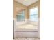 A soothing bathroom features a corner tub with tile surround and natural light from two windows at 2390 Lake Easy Rd, Babson Park, FL 33827