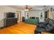A spacious bedroom features hardwood floors, a ceiling fan, a walk-in closet, and a full ensuite bathroom at 2390 Lake Easy Rd, Babson Park, FL 33827