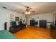 A well-lit bedroom offers ample space with hardwood floors, a ceiling fan, and neutral wall color at 2390 Lake Easy Rd, Babson Park, FL 33827