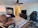 Bonus room features a bed, seating area, and desk with light-colored walls and a ceiling fan at 2390 Lake Easy Rd, Babson Park, FL 33827