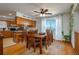 Inviting dining area featuring a wooden table, chairs and view of the serene water, perfect for enjoying meals at 2390 Lake Easy Rd, Babson Park, FL 33827