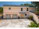 The back exterior features double doors, an entry door, and access steps to the second floor at 2390 Lake Easy Rd, Babson Park, FL 33827
