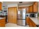 Spacious kitchen featuring stainless steel appliances and wood cabinets, perfect for cooking and entertaining guests at 2390 Lake Easy Rd, Babson Park, FL 33827