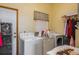 Functional laundry room with a washer, dryer, and ample storage space for household needs at 2390 Lake Easy Rd, Babson Park, FL 33827