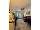 Cozy living area with a view to the patio, furnished with leather furniture and colorful rug at 2390 Lake Easy Rd, Babson Park, FL 33827