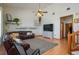 Bright living room boasts light colored walls, hardwood floors, and a leather sectional couch at 2390 Lake Easy Rd, Babson Park, FL 33827