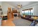 Open living room features hardwood floors, a leather couch, staircase and a view of the water at 2390 Lake Easy Rd, Babson Park, FL 33827