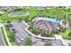 Aerial of community center with pool, lounge chairs, parking, and green space with pond in background at 2577 Canyon Crest Dr, Lakeland, FL 33811