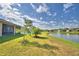 Landscaped backyard featuring a serene pond with a fountain and lush lawn at 2577 Canyon Crest Dr, Lakeland, FL 33811
