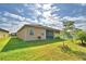 Well-maintained backyard with lush lawn, young trees, and access to screened lanai at 2577 Canyon Crest Dr, Lakeland, FL 33811