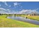Serene backyard with a pond, fountain, and well-manicured lawn at 2577 Canyon Crest Dr, Lakeland, FL 33811