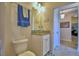 Cozy bathroom featuring a granite countertop vanity and blue accent rug for a comforting splash of color at 2577 Canyon Crest Dr, Lakeland, FL 33811