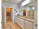Bright bathroom featuring a double vanity with granite countertops and a walk-in closet at 2577 Canyon Crest Dr, Lakeland, FL 33811