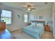 Comfortable bedroom with a ceiling fan, carpeted floor, and windows providing natural light at 2577 Canyon Crest Dr, Lakeland, FL 33811
