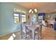 Light-filled dining room with a stylish chandelier, a neutral color palette, and sliding glass doors to the screened-in lanai at 2577 Canyon Crest Dr, Lakeland, FL 33811