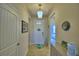 Bright entryway with a white door, decorative items, and a glimpse into the bedroom at 2577 Canyon Crest Dr, Lakeland, FL 33811