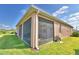 Exterior of the property featuring a screened-in lanai with garden hose and barbeque at 2577 Canyon Crest Dr, Lakeland, FL 33811