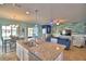 Modern kitchen with granite countertops, island seating, and a view of the living room at 2577 Canyon Crest Dr, Lakeland, FL 33811