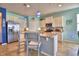 Bright kitchen with white cabinetry, stainless steel appliances, granite countertops, and island with bar seating at 2577 Canyon Crest Dr, Lakeland, FL 33811