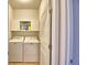 Laundry room with modern washer and dryer set, and overhead cabinets, providing convenience and storage at 2577 Canyon Crest Dr, Lakeland, FL 33811