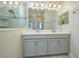Bathroom featuring a double sink vanity with ample storage and modern lighting fixtures at 2733 Attwater Loop, Winter Haven, FL 33884