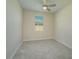 Bedroom with neutral walls, tile flooring, a ceiling fan, and a window for ample natural light at 2733 Attwater Loop, Winter Haven, FL 33884