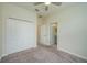 Bedroom with neutral walls, plush carpeting, closet space, and an attached bathroom providing easy access at 2733 Attwater Loop, Winter Haven, FL 33884