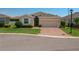 Charming single-story home featuring a brick driveway, manicured lawn, and neutral color palette at 2733 Attwater Loop, Winter Haven, FL 33884