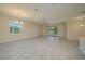 Open-concept living room featuring tile floors, a ceiling fan, and sliding glass doors at 2733 Attwater Loop, Winter Haven, FL 33884