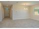 Open-concept living space featuring tile floors and a chandelier at 2733 Attwater Loop, Winter Haven, FL 33884