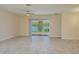 Bright living area featuring tile flooring, a ceiling fan, and glass sliding doors to the outside at 2733 Attwater Loop, Winter Haven, FL 33884
