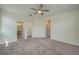 Spacious primary bedroom with neutral carpet, a ceiling fan, and ensuite bathroom at 2733 Attwater Loop, Winter Haven, FL 33884