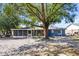 Large backyard with mature trees, large screened-in patio, and a partially shaded area at 275 Cherry Laurel Ln, Winter Haven, FL 33880