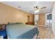 Bedroom with wood-look flooring that leads into the bathroom and kitchen at 275 Cherry Laurel Ln, Winter Haven, FL 33880