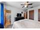 Bedroom featuring a ceiling fan, television, and view into the bathroom at 275 Cherry Laurel Ln, Winter Haven, FL 33880