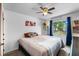 Bright bedroom featuring a ceiling fan, natural light, and modern decor at 275 Cherry Laurel Ln, Winter Haven, FL 33880