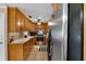 A functional kitchen featuring wooden cabinetry, tile floors, and stainless steel appliances at 275 Cherry Laurel Ln, Winter Haven, FL 33880