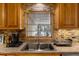 Well-appointed kitchen area featuring a sink with a window view, ample counter space, and stylish backsplash at 275 Cherry Laurel Ln, Winter Haven, FL 33880