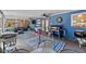 A large, covered patio featuring multiple seating areas, ceiling fans, and a grill at 275 Cherry Laurel Ln, Winter Haven, FL 33880