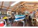 Shed interior with corrugated roof, two kayaks, a grill, and shelving at 275 Cherry Laurel Ln, Winter Haven, FL 33880