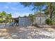 Backyard with shed and covered area providing additional storage for outdoor equipment at 275 Cherry Laurel Ln, Winter Haven, FL 33880