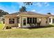 Picture of a spacious backyard with manicured lawn and a sunroom addition to the home at 284 Lake Suzanne Dr, Lake Wales, FL 33859