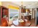 Cozy breakfast nook with wood floors, a dining table, and a view of the kitchen area, creating a seamless flow at 284 Lake Suzanne Dr, Lake Wales, FL 33859