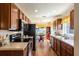 Efficient kitchen featuring wooden cabinets, stainless steel appliances, and a breakfast nook with backyard views at 284 Lake Suzanne Dr, Lake Wales, FL 33859