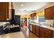 Charming kitchen with wooden cabinets, stainless steel appliances, and a view into the breakfast nook at 284 Lake Suzanne Dr, Lake Wales, FL 33859
