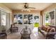 Bright sunroom with tile flooring, ceiling fan, wicker seating, and sliding glass doors at 284 Lake Suzanne Dr, Lake Wales, FL 33859