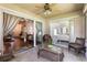 Inviting sunroom featuring tile floors, sliding glass doors, and wicker furniture with scenic views at 284 Lake Suzanne Dr, Lake Wales, FL 33859