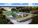 Aerial view of the property showcasing its proximity to the lake and its spacious lot with lush greenery at 302 W Gates Ave, Lake Hamilton, FL 33851