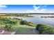 Expansive aerial view of the property with a picturesque lake, lush greenery, and a clear blue sky at 302 W Gates Ave, Lake Hamilton, FL 33851